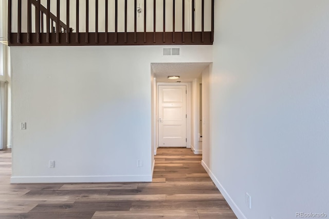 unfurnished room with visible vents, baseboards, and wood finished floors