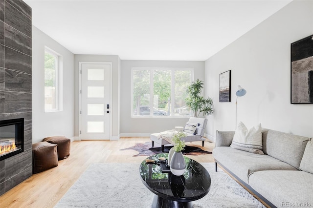 1543 Glencoe St, Denver, CO 80220 - living room with wood finished floors, healthy amount of natural light, a tile fireplace, and baseboards