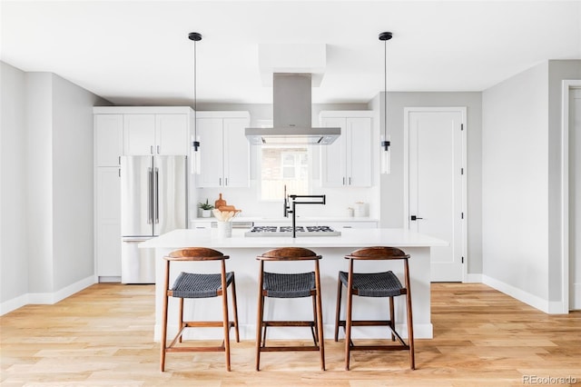 1543 Glencoe St, Denver, CO 80220 - kitchen featuring stainless steel appliances, a center island with sink, light countertops, and baseboards