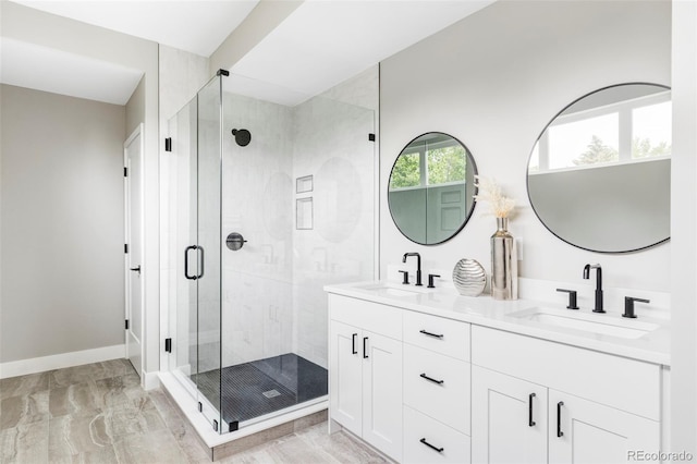 1543 Glencoe St, Denver, CO 80220 - full bathroom with double vanity, a stall shower, marble look tiles, and baseboards