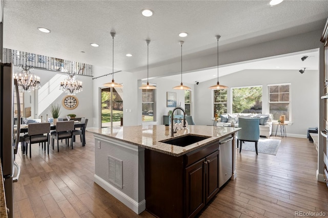 6877 Northstar Ct, Castle Rock, CO 80108 - kitchen with stainless steel appliances, hardwood / wood-style floors, dark brown cabinetry, a kitchen island with sink, and recessed lighting