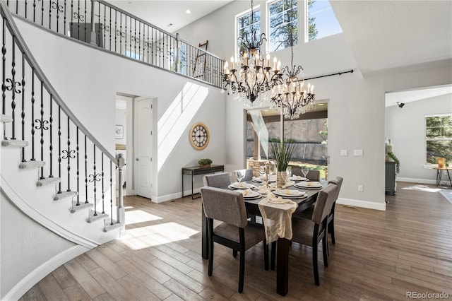 6877 Northstar Ct, Castle Rock, CO 80108 - dining space with stairs, a high ceiling, wood finished floors, and a chandelier