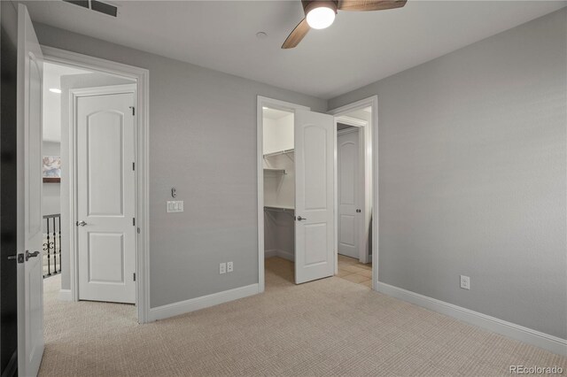 6877 Northstar Ct, Castle Rock, CO 80108 - unfurnished bedroom featuring light carpet, a walk in closet, and ceiling fan