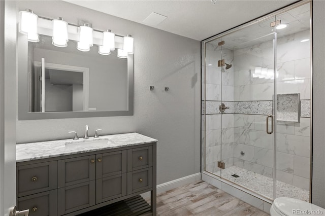 6877 Northstar Ct, Castle Rock, CO 80108 - full bathroom featuring a stall shower, vanity, and wood finished floors