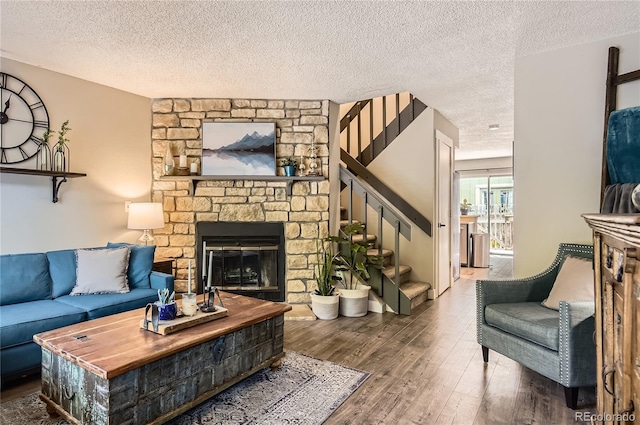 8252 S Fillmore Cir, Centennial, CO 80122 - living area with stairs, a textured ceiling, wood finished floors, and a fireplace