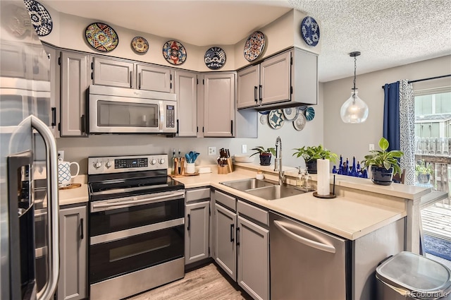 8252 S Fillmore Cir, Centennial, CO 80122 - kitchen featuring appliances with stainless steel finishes, gray cabinetry, healthy amount of natural light, and light countertops