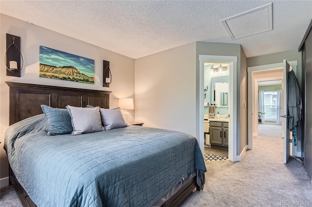 8252 S Fillmore Cir, Centennial, CO 80122 - bedroom featuring light carpet, attic access, a textured ceiling, and ensuite bathroom