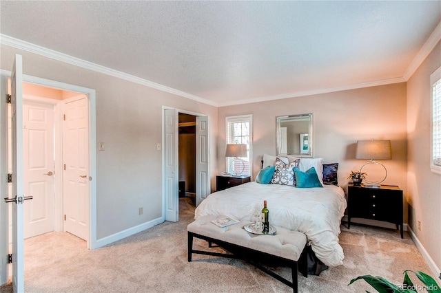 bedroom with crown molding, baseboards, and light colored carpet