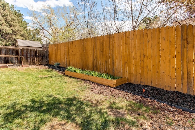 view of yard with a fenced backyard and a vegetable garden