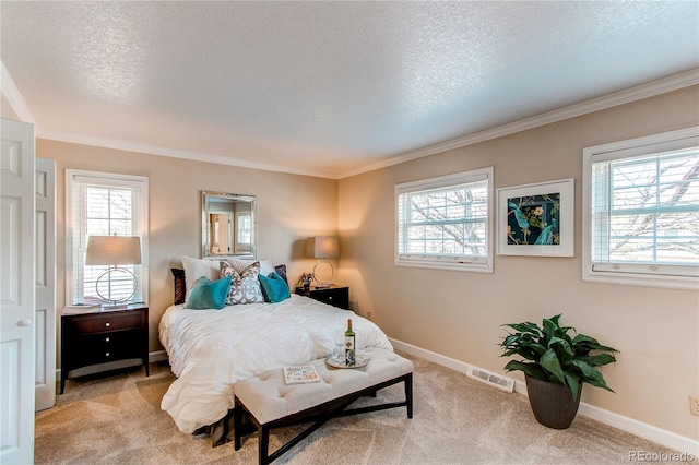 bedroom featuring a textured ceiling, light colored carpet, crown molding, visible vents, and baseboards