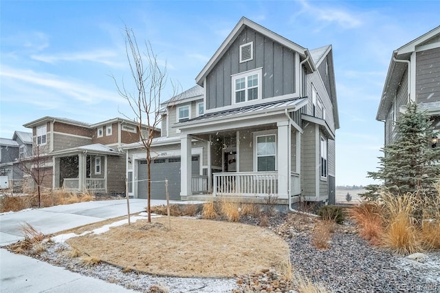 view of front of house with a standing seam roof, metal roof, covered porch, concrete driveway, and board and batten siding