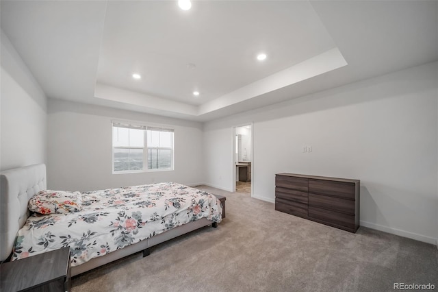 carpeted bedroom featuring baseboards, a tray ceiling, and recessed lighting