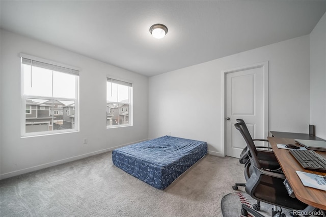 bedroom with carpet floors and baseboards