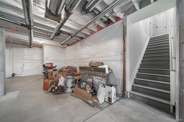 unfinished basement featuring stairway