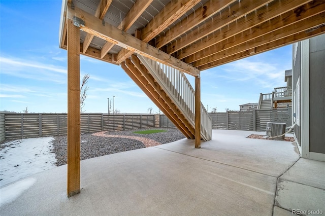 view of patio featuring fence private yard, central AC, and stairs