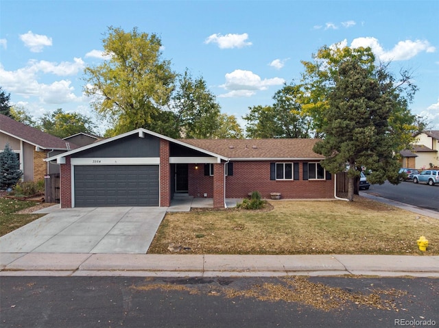 single story home featuring a garage and a front lawn