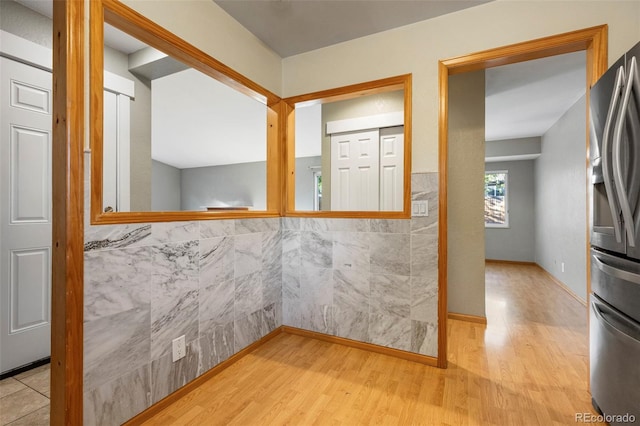 interior space featuring hardwood / wood-style flooring and tile walls