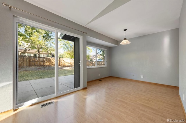 interior space featuring lofted ceiling and light hardwood / wood-style floors