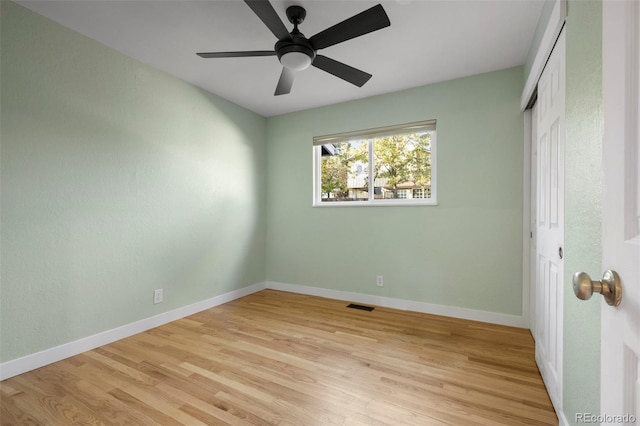 unfurnished bedroom with a closet, light wood-type flooring, and ceiling fan