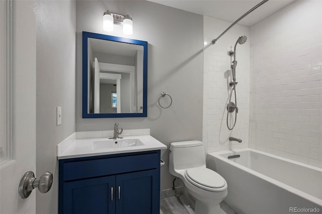 full bathroom with tiled shower / bath, vanity, and toilet