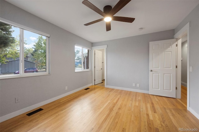 unfurnished bedroom with ceiling fan and light wood-type flooring