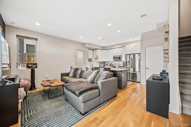 1302 N Stuart St, Denver, CO 80204 - living area featuring stairway, light wood-style flooring, and recessed lighting