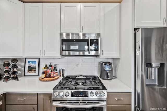 1302 N Stuart St, Denver, CO 80204 - kitchen featuring appliances with stainless steel finishes, light countertops, decorative backsplash, and white cabinets