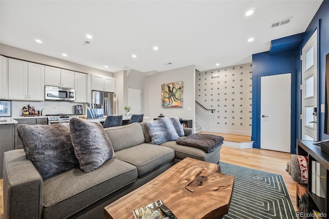 1302 N Stuart St, Denver, CO 80204 - living room with stairs, light wood finished floors, and recessed lighting
