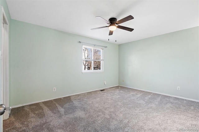 carpeted spare room with ceiling fan