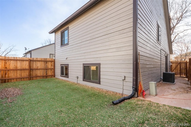 back of house with a patio area and a lawn