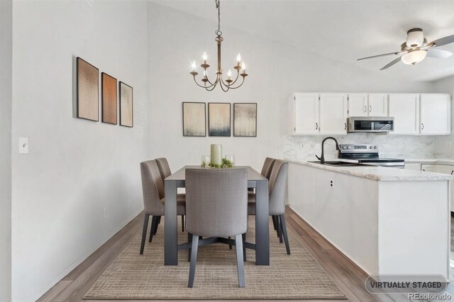 10731 W 63rd Ave Unit A, Arvada, CO 80004 - dining room with a chandelier, light wood-type flooring, lofted ceiling, and a ceiling fan