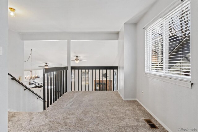 10731 W 63rd Ave Unit A, Arvada, CO 80004 - corridor featuring carpet, a chandelier, a sink, baseboards, and an upstairs landing