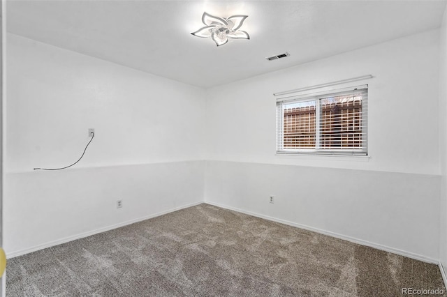 carpeted spare room with baseboards and visible vents