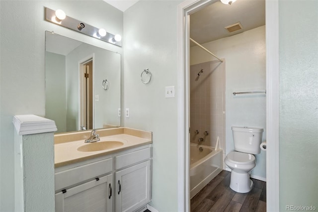 full bath with vanity, visible vents, wood finished floors, toilet, and shower / bathing tub combination