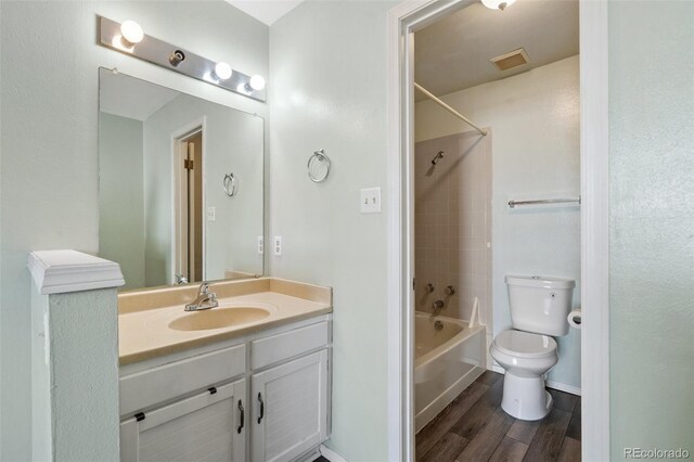 10731 W 63rd Ave Unit A, Arvada, CO 80004 - full bathroom with vanity, toilet, wood finished floors, and shower / tub combination