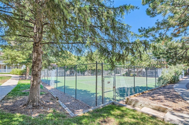 view of tennis court featuring fence