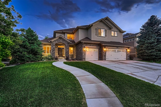 view of front of house featuring a yard and a garage