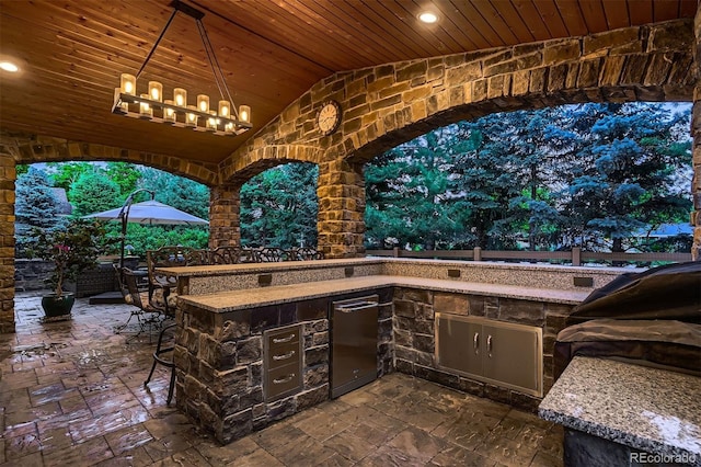 view of patio with a bar and exterior kitchen