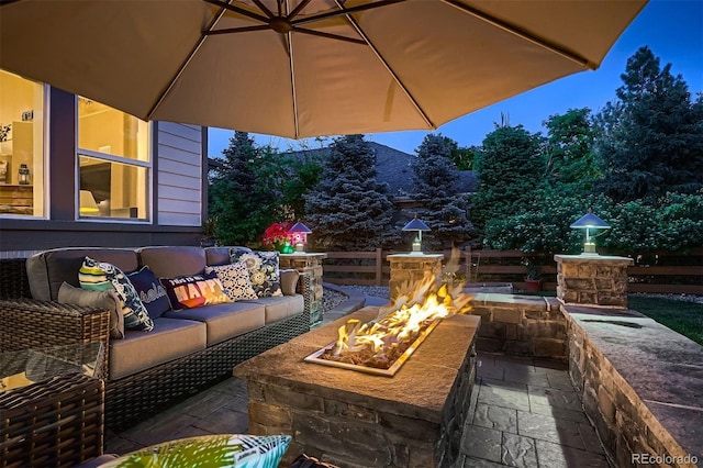 view of patio featuring an outdoor living space with a fire pit