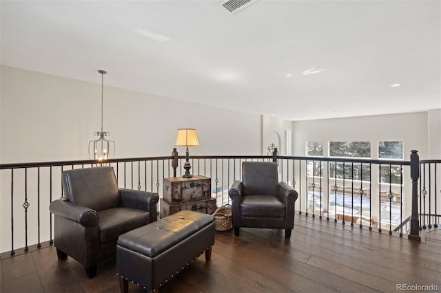 living area featuring dark hardwood / wood-style floors and a notable chandelier