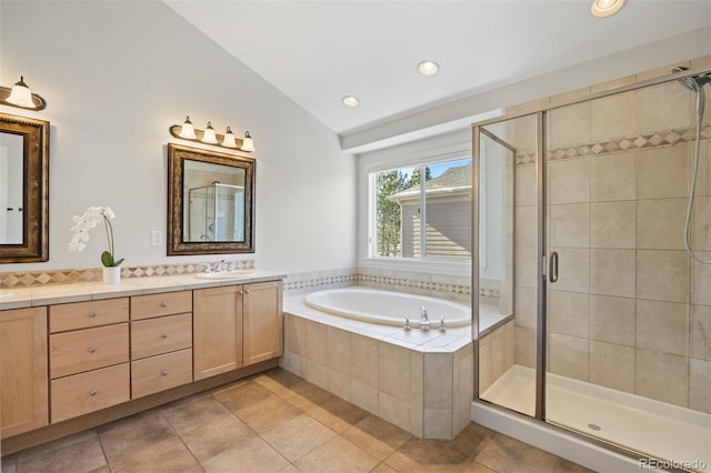 bathroom with lofted ceiling, shower with separate bathtub, tile patterned flooring, and vanity