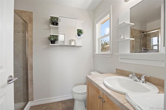 bathroom featuring vanity, toilet, and an enclosed shower