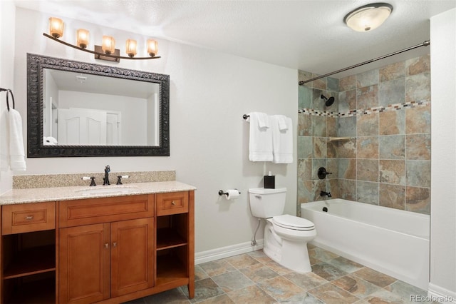 full bathroom with vanity, toilet, tiled shower / bath combo, and a textured ceiling