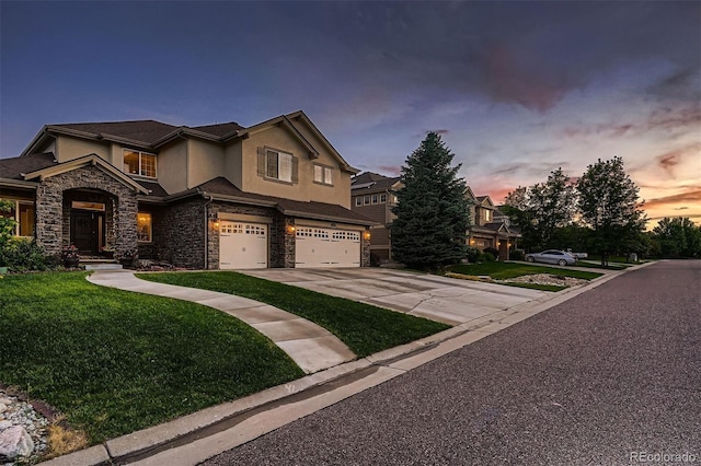 view of front of home featuring a garage and a lawn