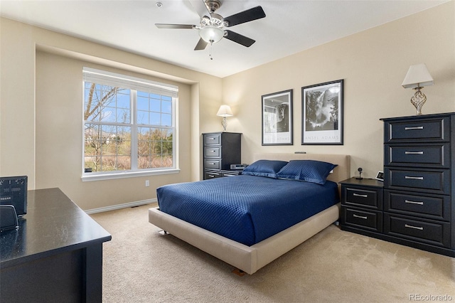 bedroom featuring baseboards, ceiling fan, and light colored carpet
