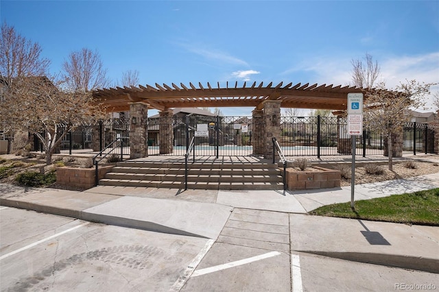 view of community with fence, a pergola, and a pool
