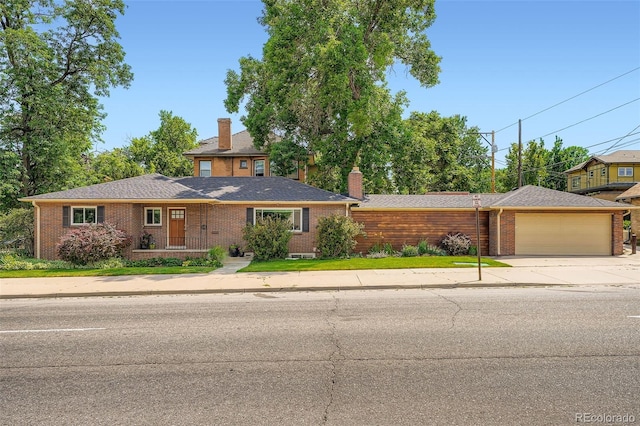 3530 E 8th Ave, Denver, CO 80206 - view of front facade featuring a chimney, brick siding, driveway, and a garage