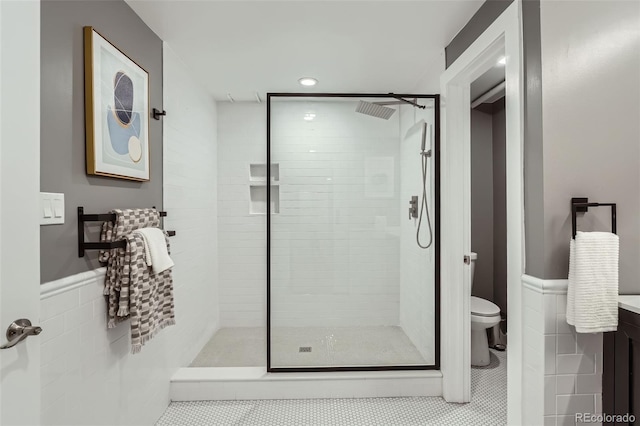 3530 E 8th Ave, Denver, CO 80206 - bathroom with tiled shower, vanity, wainscoting, tile patterned floors, and tile walls