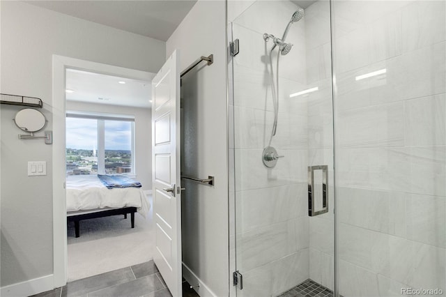 bathroom with an enclosed shower and tile patterned floors