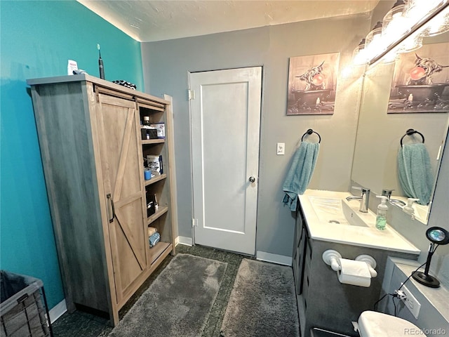 bathroom with baseboards and vanity